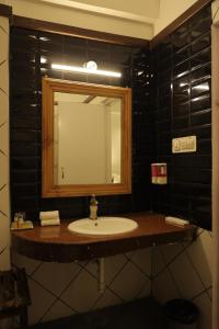 a bathroom with a sink and a mirror at Chirmi Palace - A Heritage Home in Jaipur +7 photos