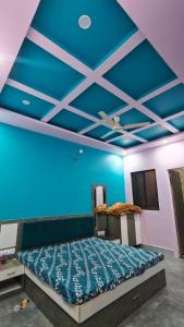 a bedroom with a blue ceiling and a bed at MMB Hotel in Bikaner +12 photos