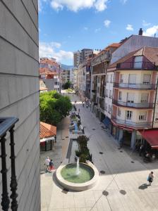 a view of a city street with a fountain at Centro1 in Vilagarcia de Arousa