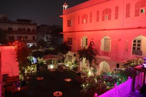 an aerial view of a building at night with lights at Chirmi Palace - A Heritage Home in Jaipur
