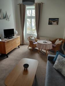 a living room with a couch and a table at Pension Villa Sophia in Sassnitz