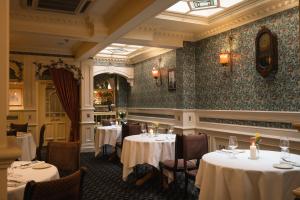 a dining room with tables and chairs in a restaurant at Arbutus Hotel in Killarney +20 photos