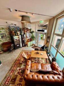 a living room with a leather couch and a table at aappartel APARTHOTEL Herford in Herford