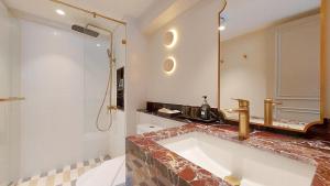 a bathroom with a large tub and a shower at Marwin Monique Hotel in Bangkok +20 photos
