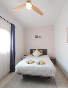 a bedroom with a bed with a ceiling fan at La Casita de Puerto in Puerto del Rosario