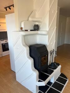 a fireplace in the middle of a living room at Leilighet i Vadsø in Vadsø