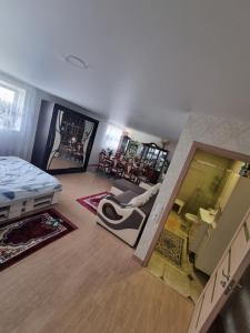 an aerial view of a bedroom with a bed and a living room at Natural oasis in Vilainiai