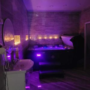 a purple bathroom with a tub and a sink at Natural oasis in Vilainiai