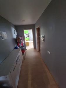 a room with a hallway with a counter and a door at Natural oasis in Vilainiai