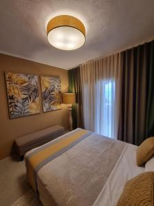 a bedroom with a large bed and a window at Villa Musa with private pool in Afitos +40 photos