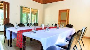 a meeting room with a table with chairs at Samburu Elephant Lodge - Inside Samburu National Reserve in Buffalo Springs  National Reserve
