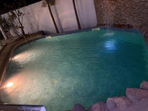 a swimming pool in a house with blue water at Luciana annexe in Mbour