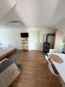 a living room with a table and a fireplace at Im Wald in Gleiszellen-Gleishorbach