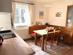 a kitchen and dining room with a table and chairs at Landhaus Bender Ferienwohnung mit Terrasse und Garten in Straden +29 photos