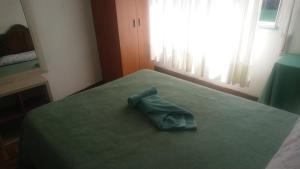 a green pillow sitting on a bed in a bedroom at Rooms Melide in Melide +16 photos