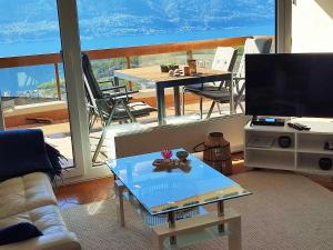 a living room with a tv and a table at Ferienwohnung C06 in Orselina