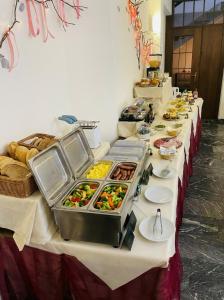 a buffet line of food on a table at Hotel Chalet du Soleil in Torgnon +35 photos
