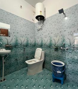 a bathroom with a toilet and a sink at Bhadraj Valley Homestay in Dehradun