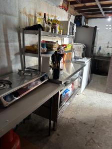 a counter in a kitchen with an open refrigerator at D Bamboo House in Mabini
