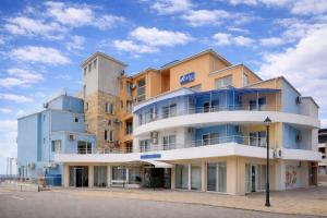 a building on the side of a street at Lotos Hotel in Balchik