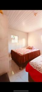 a bedroom with two beds and a window at Casa de veraneio jacuma in Conde +16 photos