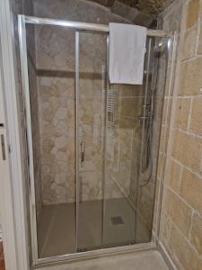 a shower with a glass door in a bathroom at casa Carlos in Bari Palese +2 photos