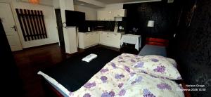 a bedroom with a bed with a remote control on it at K14 Rooms Lublin in Lublin