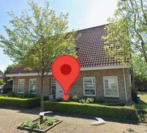 a red marker in front of a house at Beijerse inn in Nieuw-Beijerland