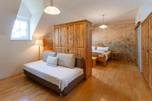 a bedroom with a bed and a cabinet in a room at Landhaus Bender Ferienwohnung mit Terrasse und Garten in Straden