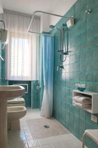 a bathroom with a shower and a toilet and a sink at ELIOS Grand Apartment in Tropea +20 photos