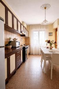 a kitchen with a white table and a white table and a tableablish at ELIOS Grand Apartment in Tropea