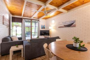 a living room with a couch and a table at Reef Villa- Kalbarri Central with Pool in Kalbarri