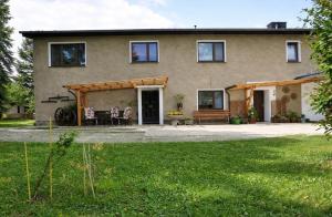 a house with a patio in front of it at Ferienwohnung Fam.Stecher in Malschwitz