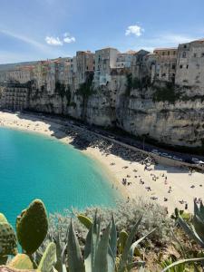 a beach with a group of people and buildings at ELIOS Grand Apartment in Tropea