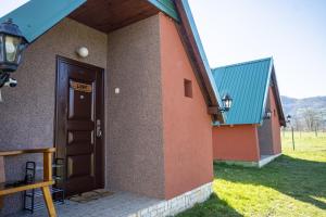 a building with a door with a sign on it at Rest&peace homes in Mojkovac