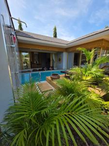 a house with a swimming pool in the yard at Golden Villa in Ko Phangan