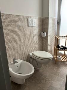 a bathroom with a toilet and a sink at Dioniso Affittacamere in Conversano +24 photos