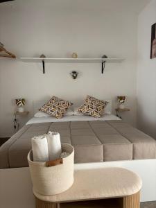 a bedroom with a large bed with a shelf on the wall at Dioniso Affittacamere in Conversano