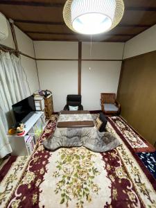 a bedroom with a large bed and a large rug at 耀来YoRaiようらい in Nagaokakyo