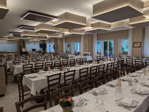 a banquet hall with tables and chairs in a room at Hotel Ristorante Sasso Remenno in Val Masino