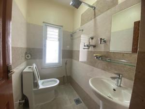 a bathroom with a toilet and a sink at Monastery View Homestay in Kathmandu +27 photos