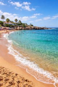 a beach with people swimming in the water at Dar AMIRA in Ben Yakhlef