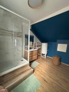 a large bathroom with a shower and a sink at Le Grand Bleu in Troyes