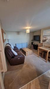 a living room with a couch and a table at Penbryn Holidays No 2 in Barmouth