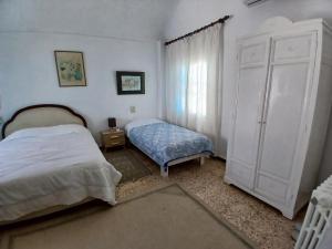 a bedroom with a bed and a large white cabinet at Raf Guest House in Sidi Bou Saïd +11 photos