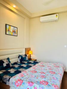 a bedroom with a bed and a air conditioner at Luxury stays in Greater Noida
