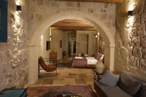 an archway in a room with a bedroom at Cappadocia Vita Cave Hotel in Ürgüp +75 photos