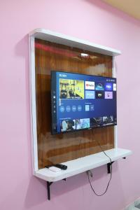 a flat screen tv hanging on a wall at Hotel Dipak in Himatnagar