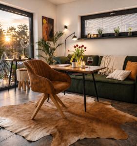 a living room with a table and a couch at Záhradný domček pri Slovenskom raji in Smižany +36 photos