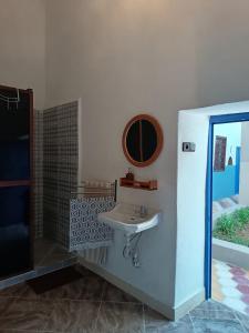 a bathroom with a sink and a mirror at RiadTiznitSouss Votre oasis privée à Tiznit in Tiznit +38 photos